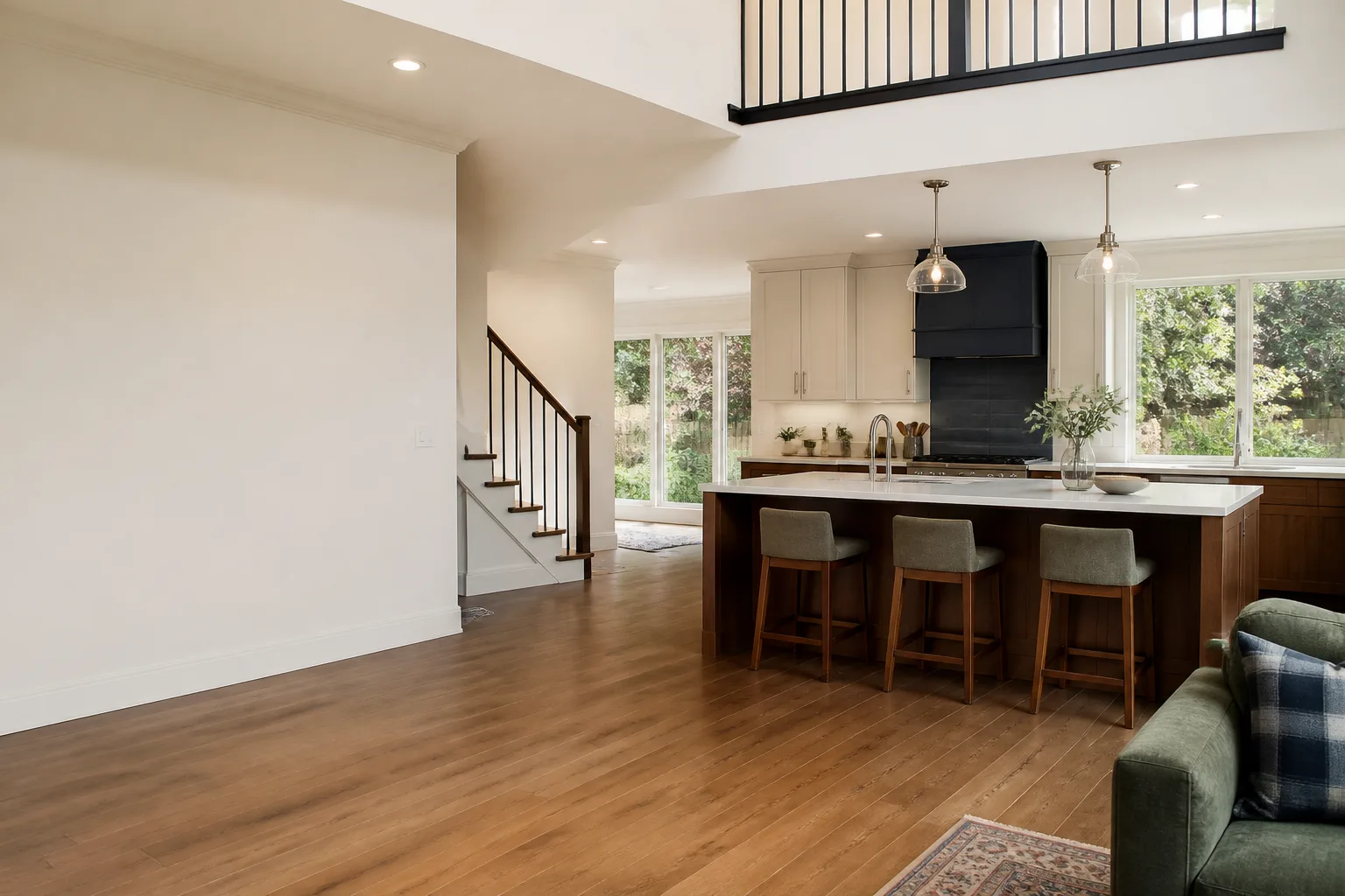 A remodeled open kitchen with a wood island and a painted range wall